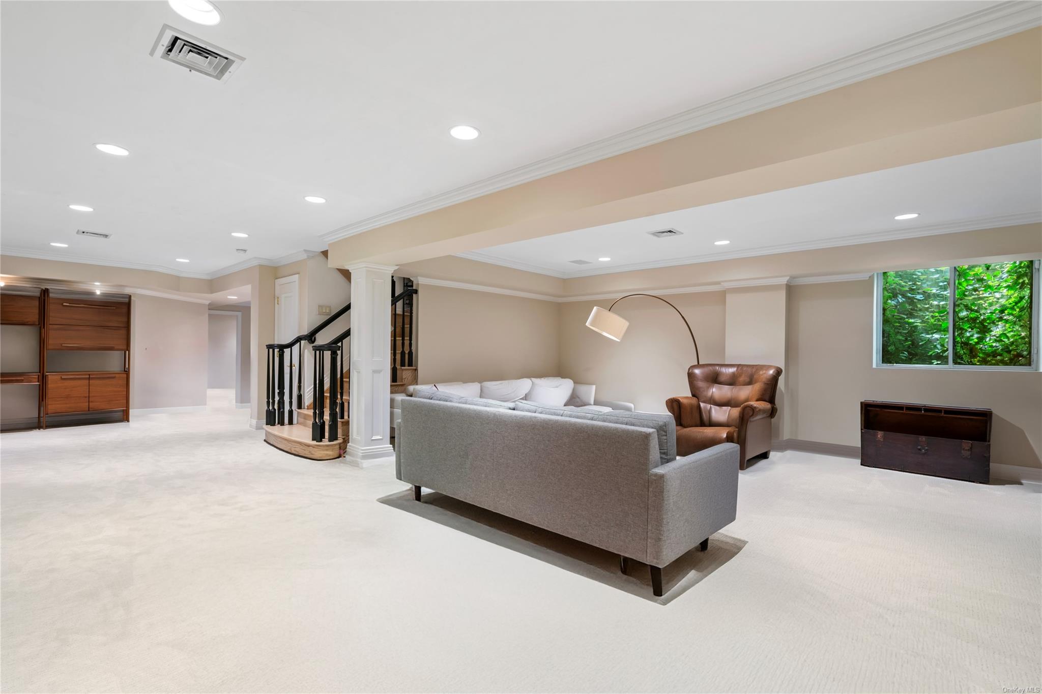 8 Holiday Pond Road Jericho, NY 11753 - Photo 30 of 43 Living area with light colored carpet, crown molding, recessed lighting, decorative columns, and stairs