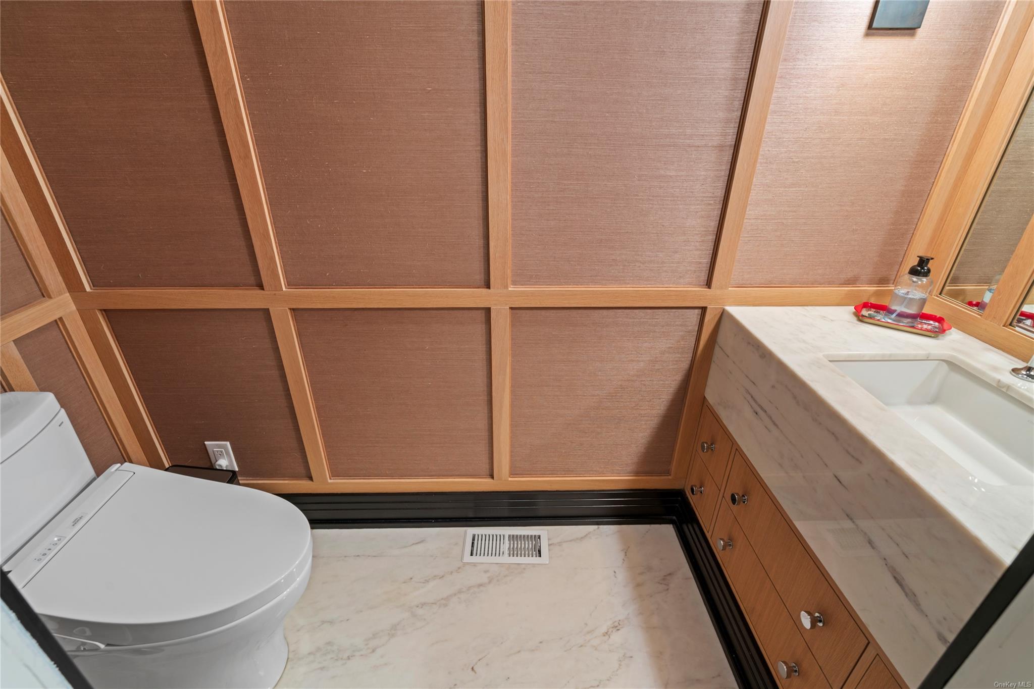 8 Holiday Pond Road Jericho, NY 11753 - Photo 33 of 43 Half bathroom with vanity and marble finish flooring