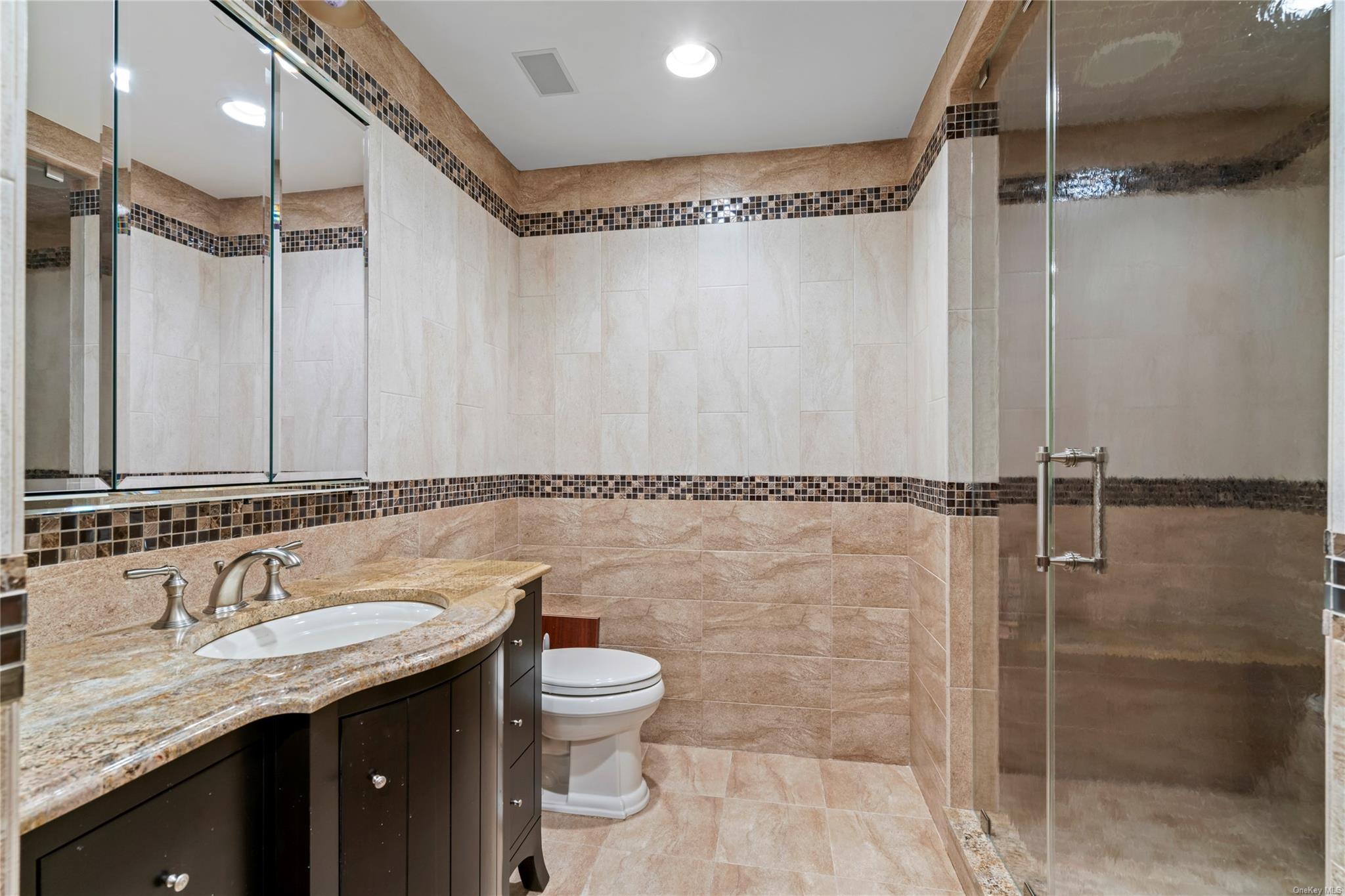 8 Holiday Pond Road Jericho, NY 11753 - Photo 34 of 43 Bathroom with vanity, tile walls, and a shower stall