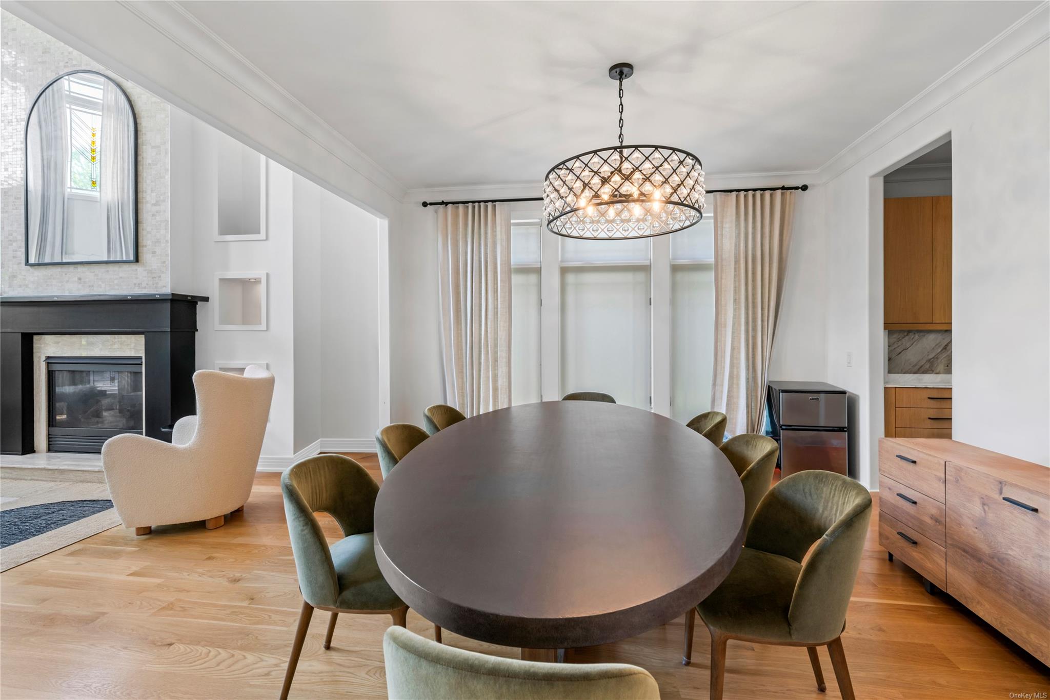 8 Holiday Pond Road Jericho, NY 11753 - Photo 8 of 43 Dining space with a chandelier, light wood finished floors, ornamental molding, and a glass covered fireplace