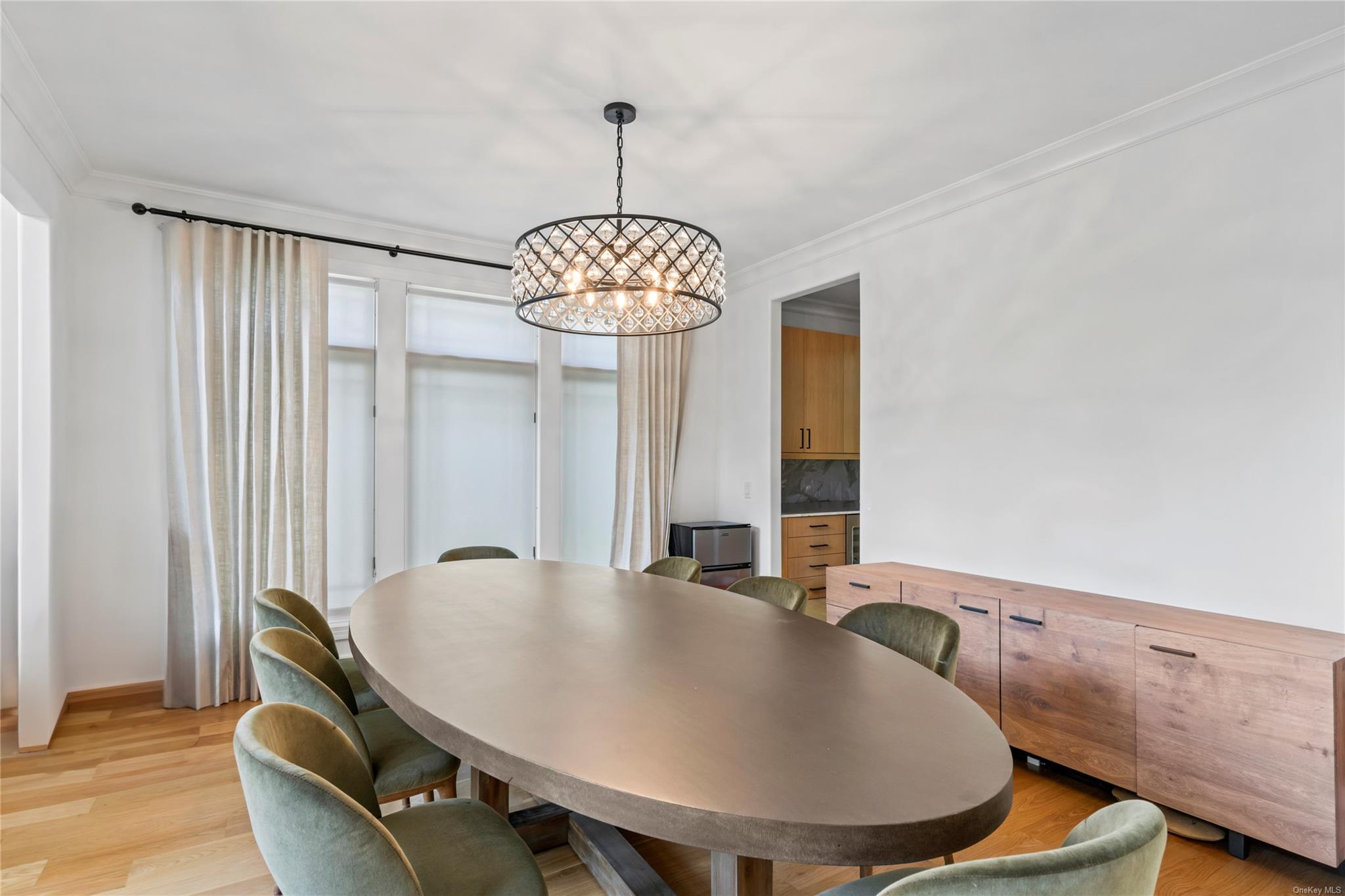 8 Holiday Pond Road Jericho, NY 11753 - Photo 9 of 43 Dining room with a chandelier, crown molding, and light wood finished floors