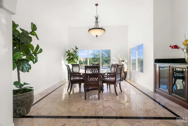 a room with furniture pool table and windows