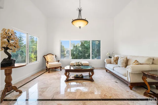 a kitchen with stainless steel appliances granite countertop a refrigerator a sink dishwasher a stove and a microwave oven