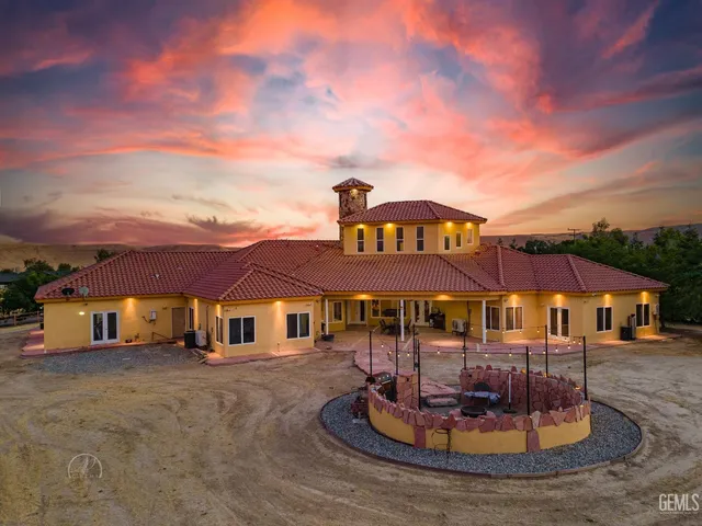 a view of a city with lawn chairs under an umbrella