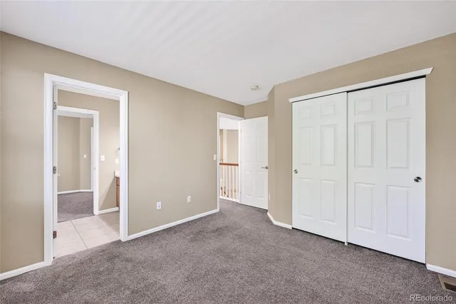 a view of an empty room and closet area