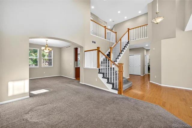 a view of a hallway with entryway and stairs