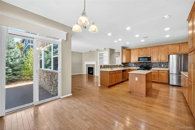 a view of kitchen with granite countertop stainless steel appliances cabinets a sink and a large window