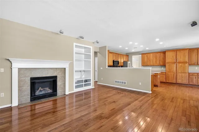 a view of a room with wooden floor and fireplace