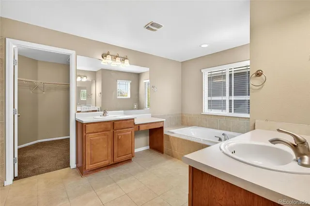 a spacious bathroom with a sink double vanity and a mirror