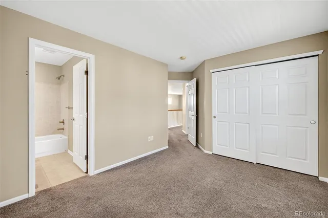 an empty room with a bathroom and a sink