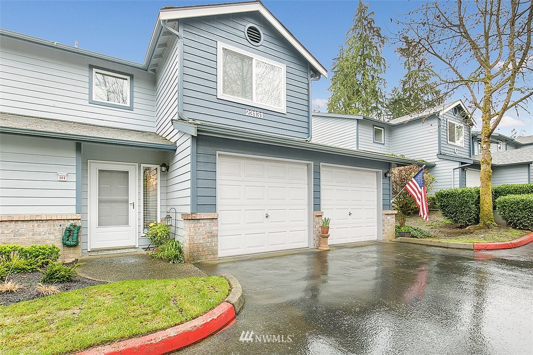 23131 15th Avenue Southeast, Unit H4 Bothell, WA 98021 - Photo 1 of 16 a view of a white house with a small yard and plants