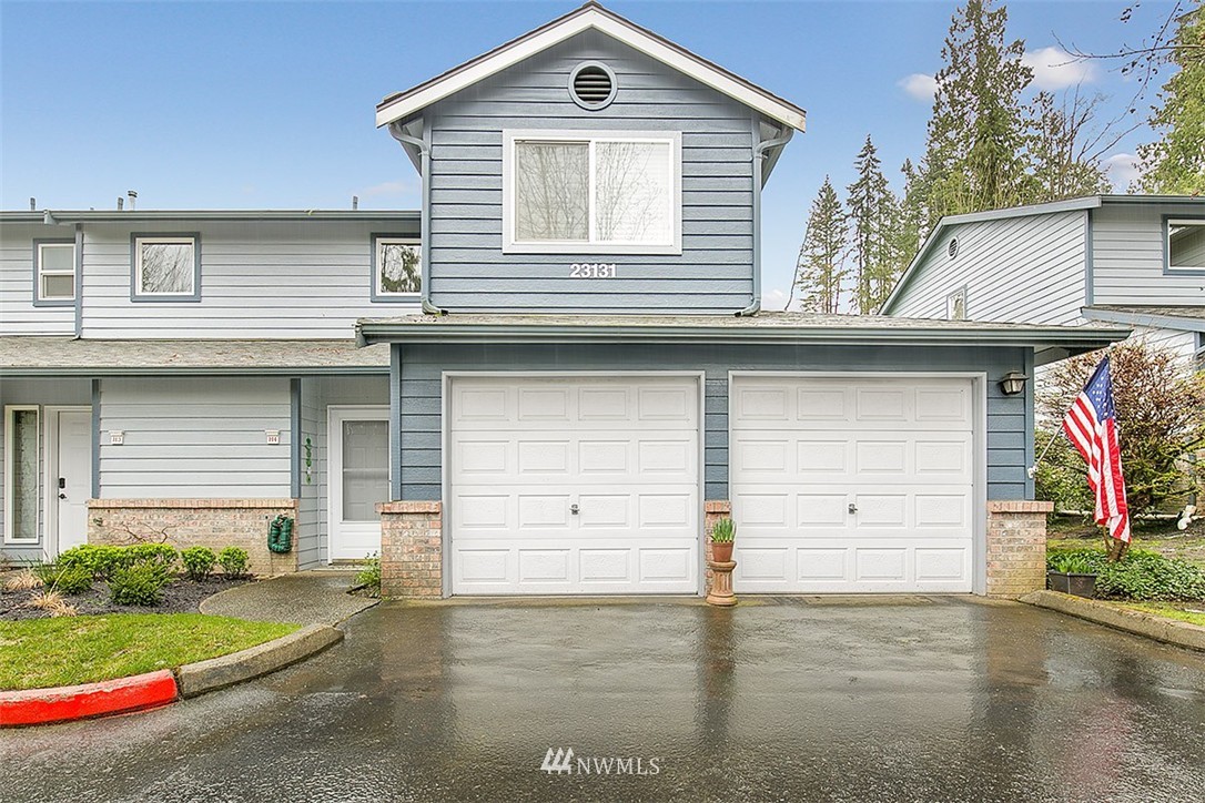 23131 15th Avenue Southeast, Unit H4 Bothell, WA 98021 - Photo 2 of 16 a view of a house with a yard and garage