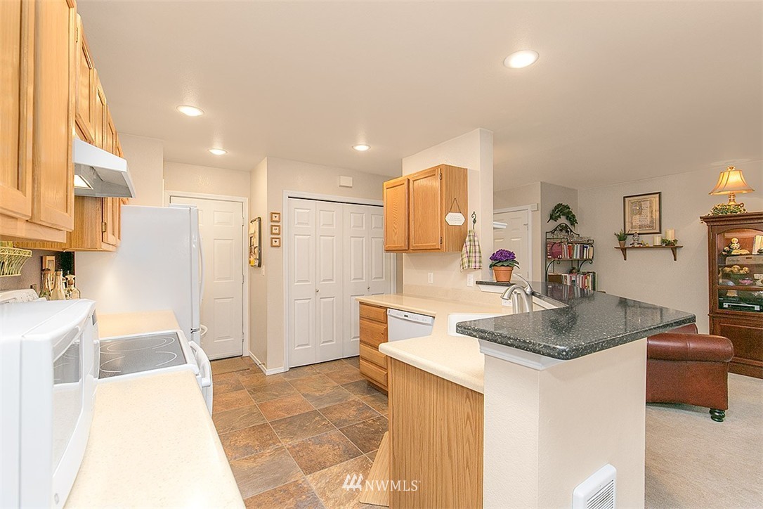 23131 15th Avenue Southeast, Unit H4 Bothell, WA 98021 - Photo 7 of 16 a kitchen with a sink cabinets and refrigerator