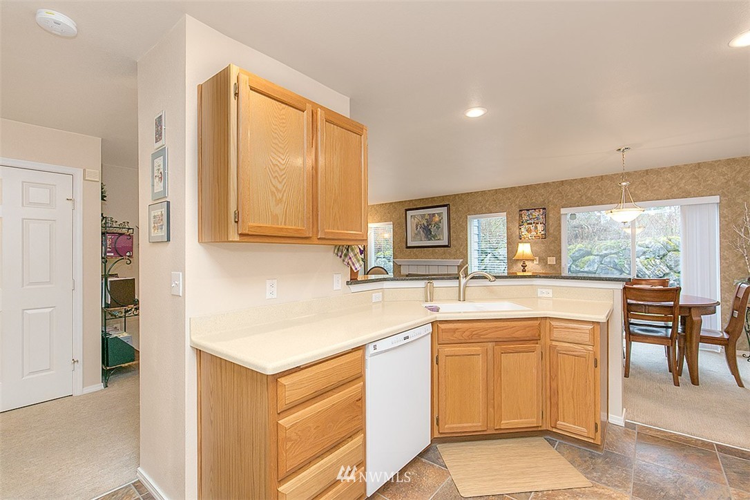 23131 15th Avenue Southeast, Unit H4 Bothell, WA 98021 - Photo 8 of 16 a kitchen with white cabinets and white appliances