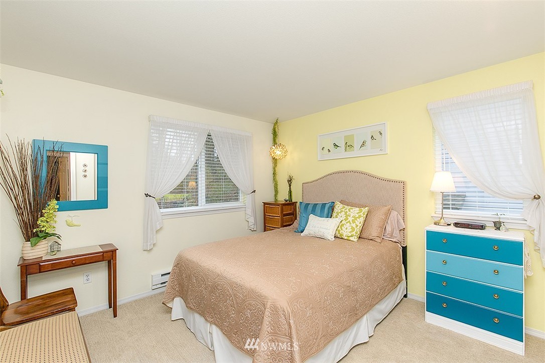 23131 15th Avenue Southeast, Unit H4 Bothell, WA 98021 - Photo 9 of 16 a bedroom with a bed and windows