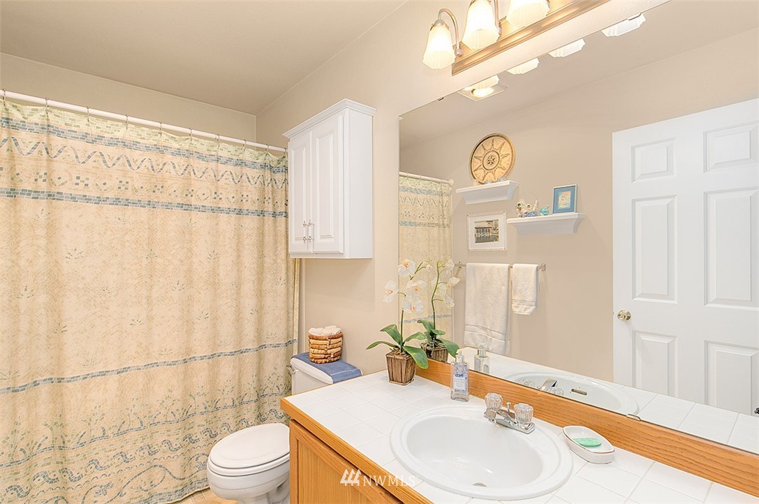 23131 15th Avenue Southeast, Unit H4 Bothell, WA 98021 - Photo 10 of 16 a bathroom with a sink vanity mirror and toilet