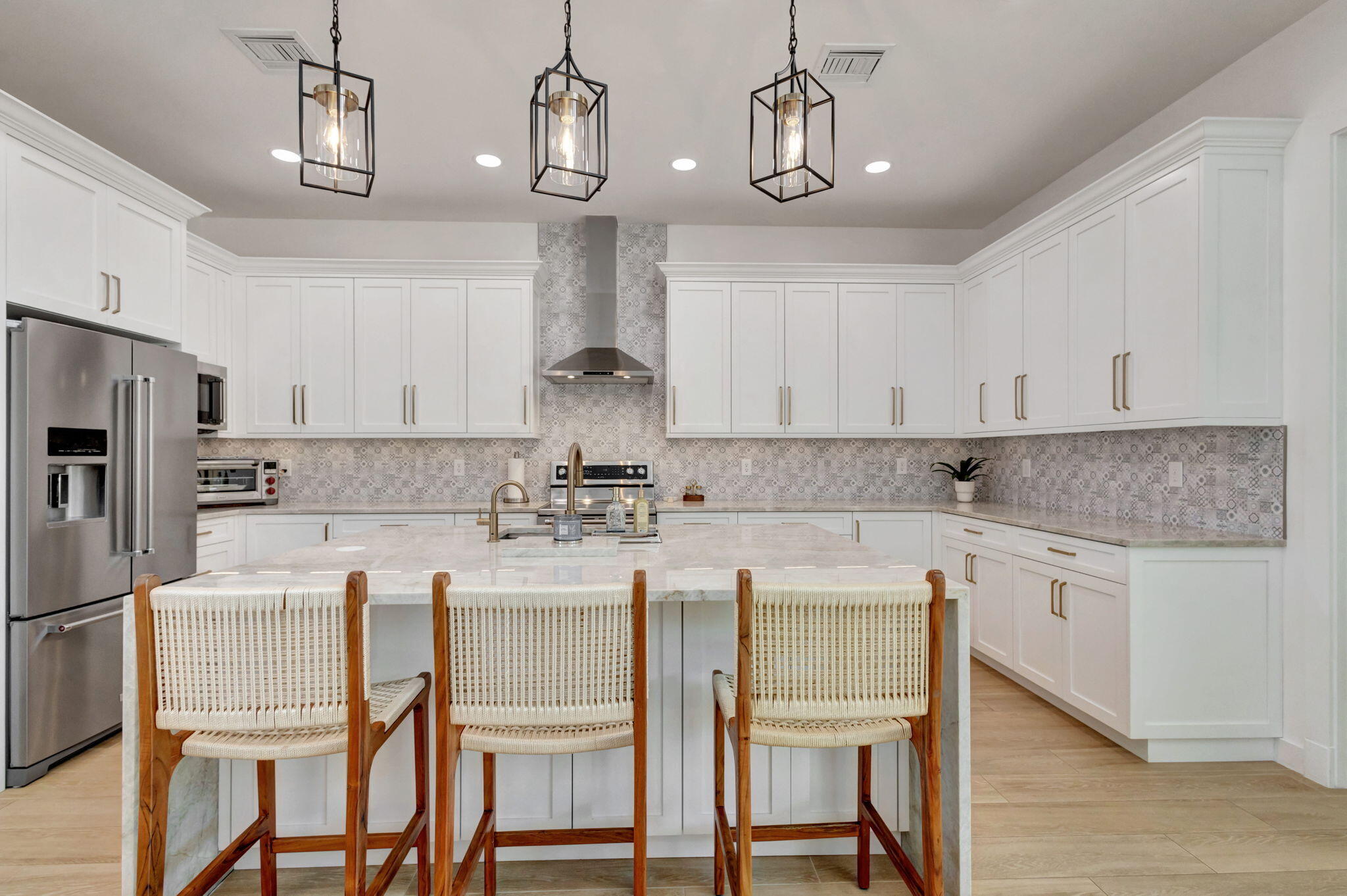 12952 Drayton Road North Palm Beach, FL 33408 - Photo 34 of 109 a kitchen with a dining table chairs cabinets and stainless steel appliances