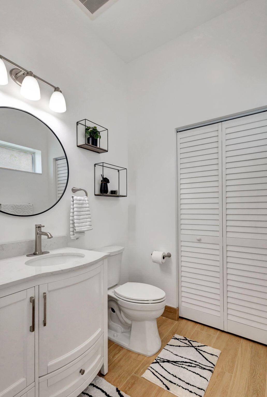 12952 Drayton Road North Palm Beach, FL 33408 - Photo 44 of 109 a bathroom with a toilet a sink and mirror
