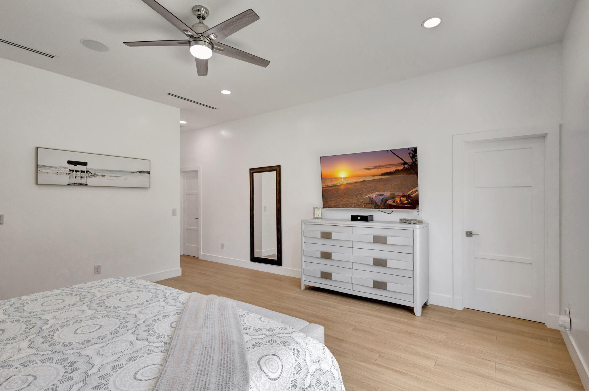 12952 Drayton Road North Palm Beach, FL 33408 - Photo 47 of 109 a view of a livingroom with cabinet a flat screen tv and a ceiling fan