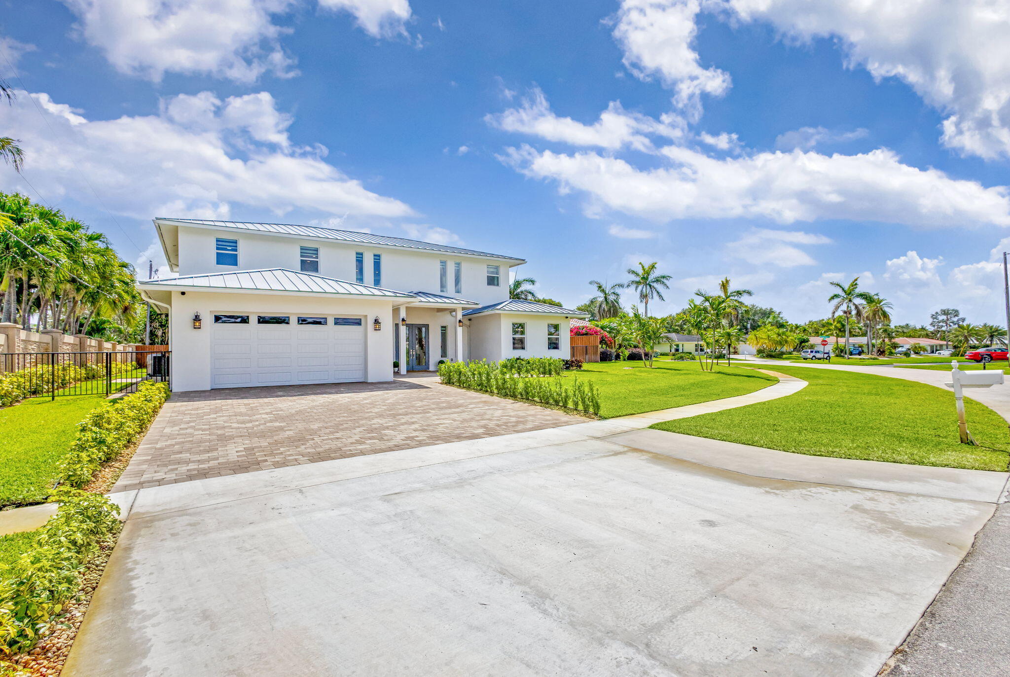 12952 Drayton Road North Palm Beach, FL 33408 - Photo 5 of 109 a front view of a house with a yard and garage