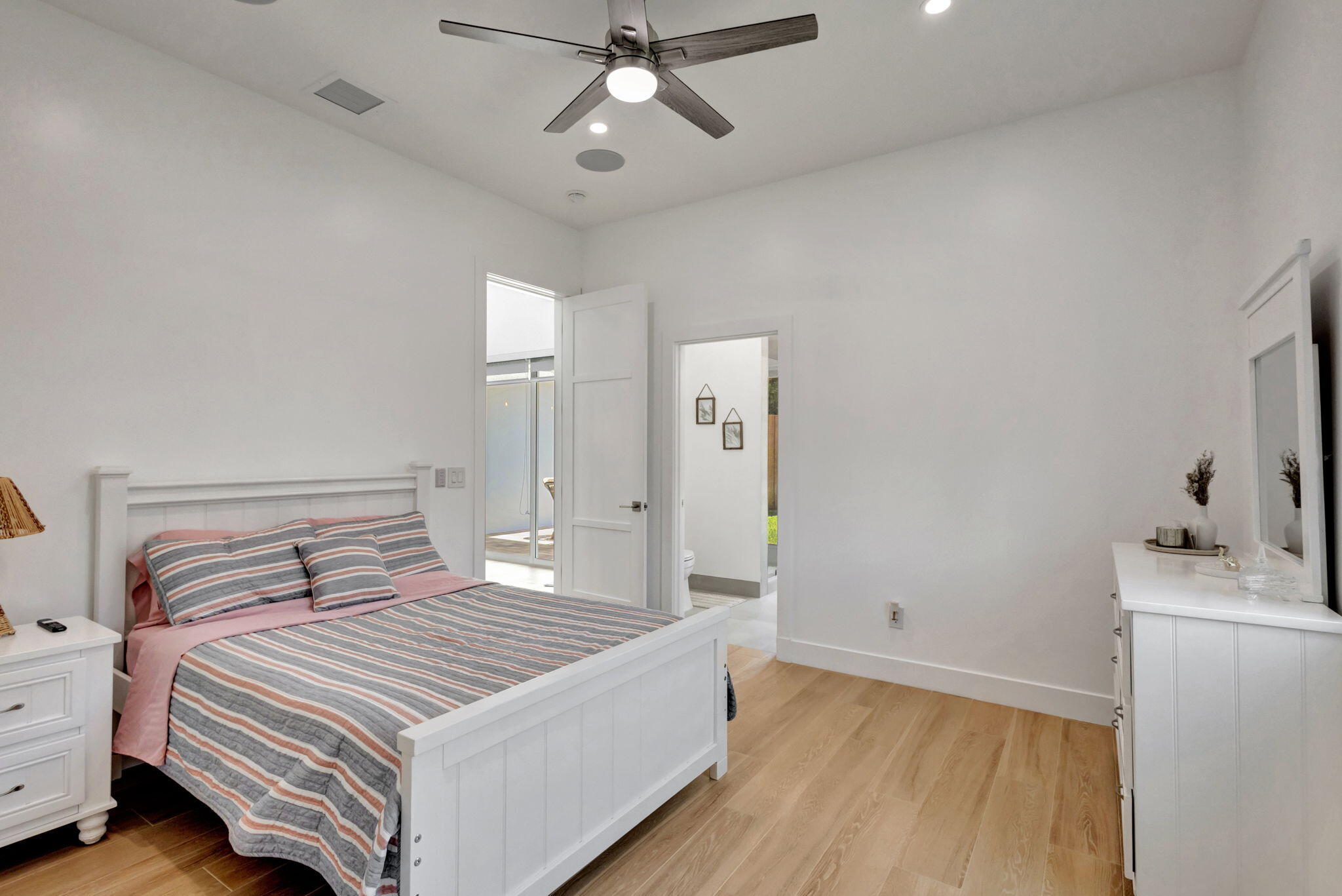 12952 Drayton Road North Palm Beach, FL 33408 - Photo 52 of 109 a bedroom with a bed and a chandelier