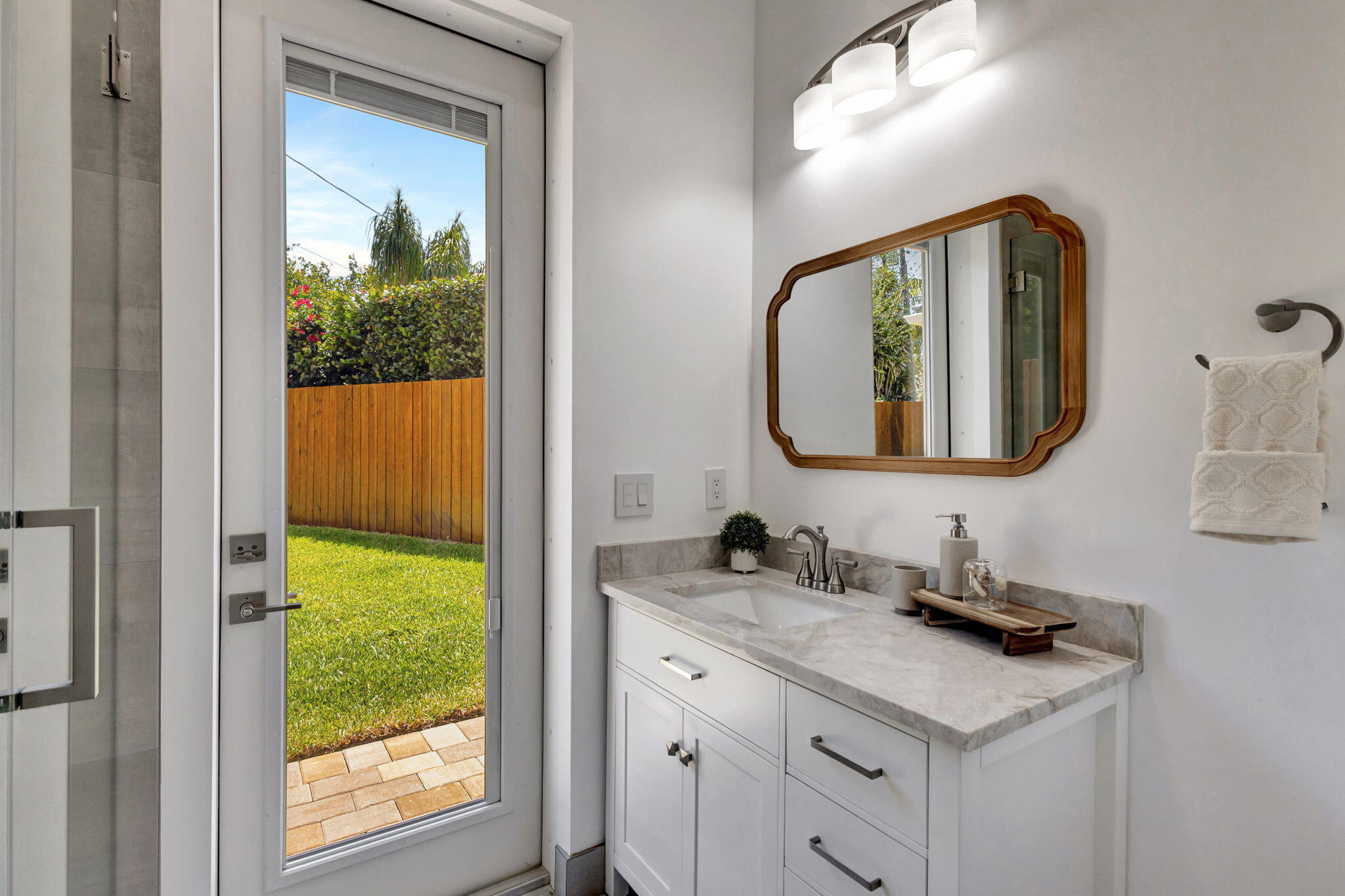 12952 Drayton Road North Palm Beach, FL 33408 - Photo 53 of 109 a bathroom with a vanity a sink a mirror and a window