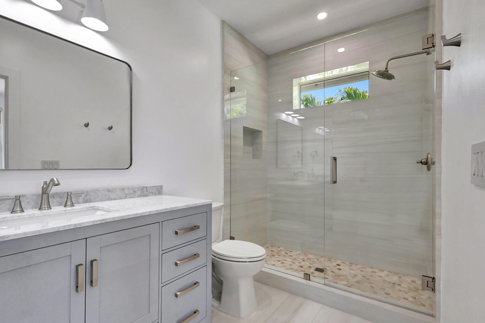 12952 Drayton Road North Palm Beach, FL 33408 - Photo 78 of 109 a bathroom with a granite countertop sink a toilet and a mirror