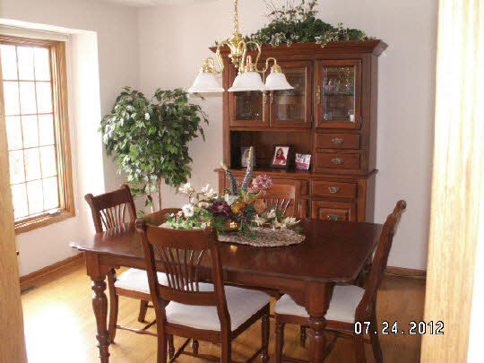 11884 Lerwick Road Caledonia, IL 61011 - Photo 5 of 11 a view of a dining room with furniture and chandelier