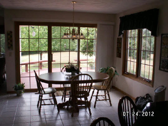 11884 Lerwick Road Caledonia, IL 61011 - Photo 6 of 11 a view of a dining room with furniture window and outside view