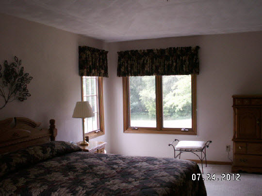 11884 Lerwick Road Caledonia, IL 61011 - Photo 8 of 11 a bedroom with a bed and wooden floor