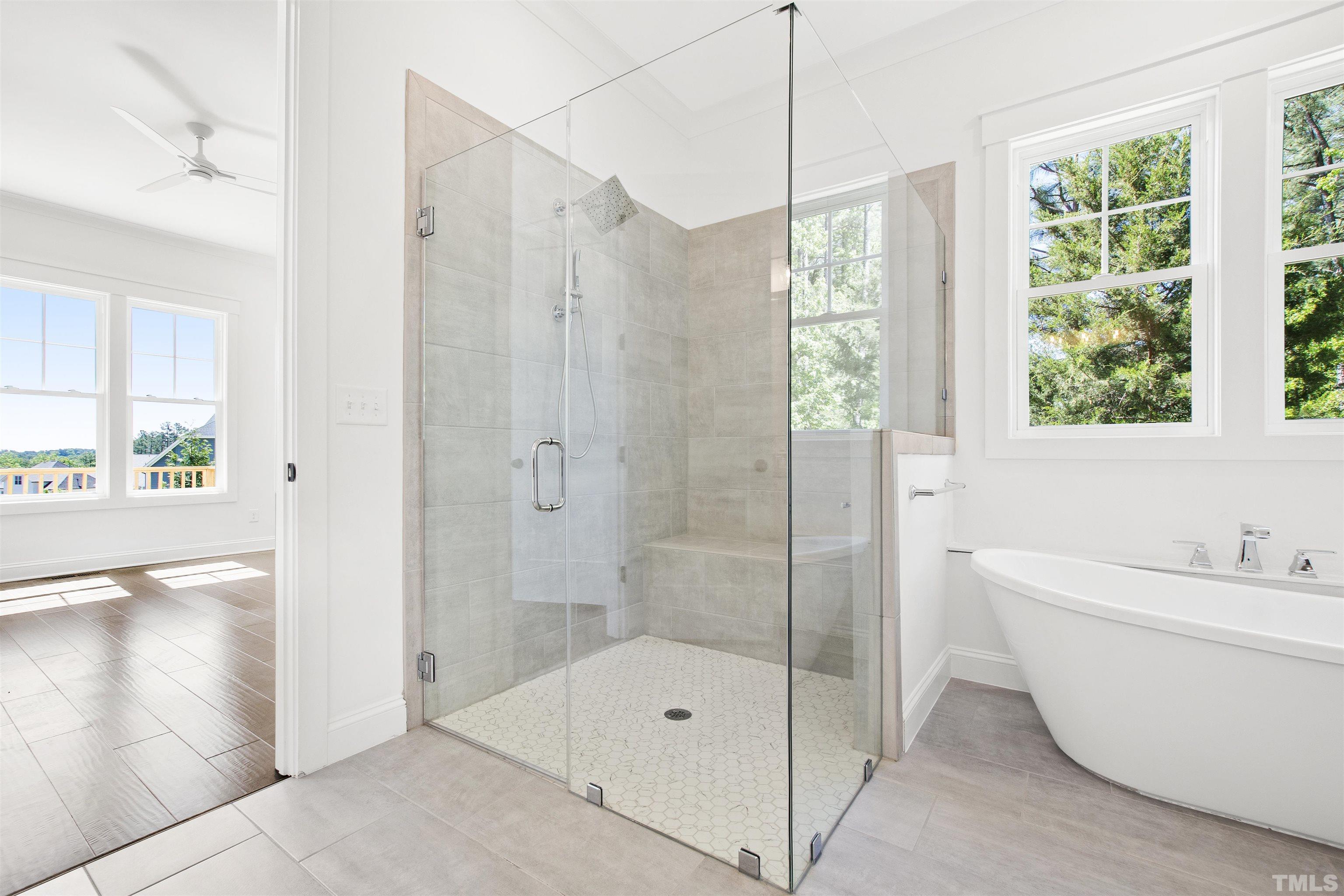 7512 Pinecrest Road Raleigh, NC 27613 - Photo 22 of 47 a bathroom with a bathtub and a shower
