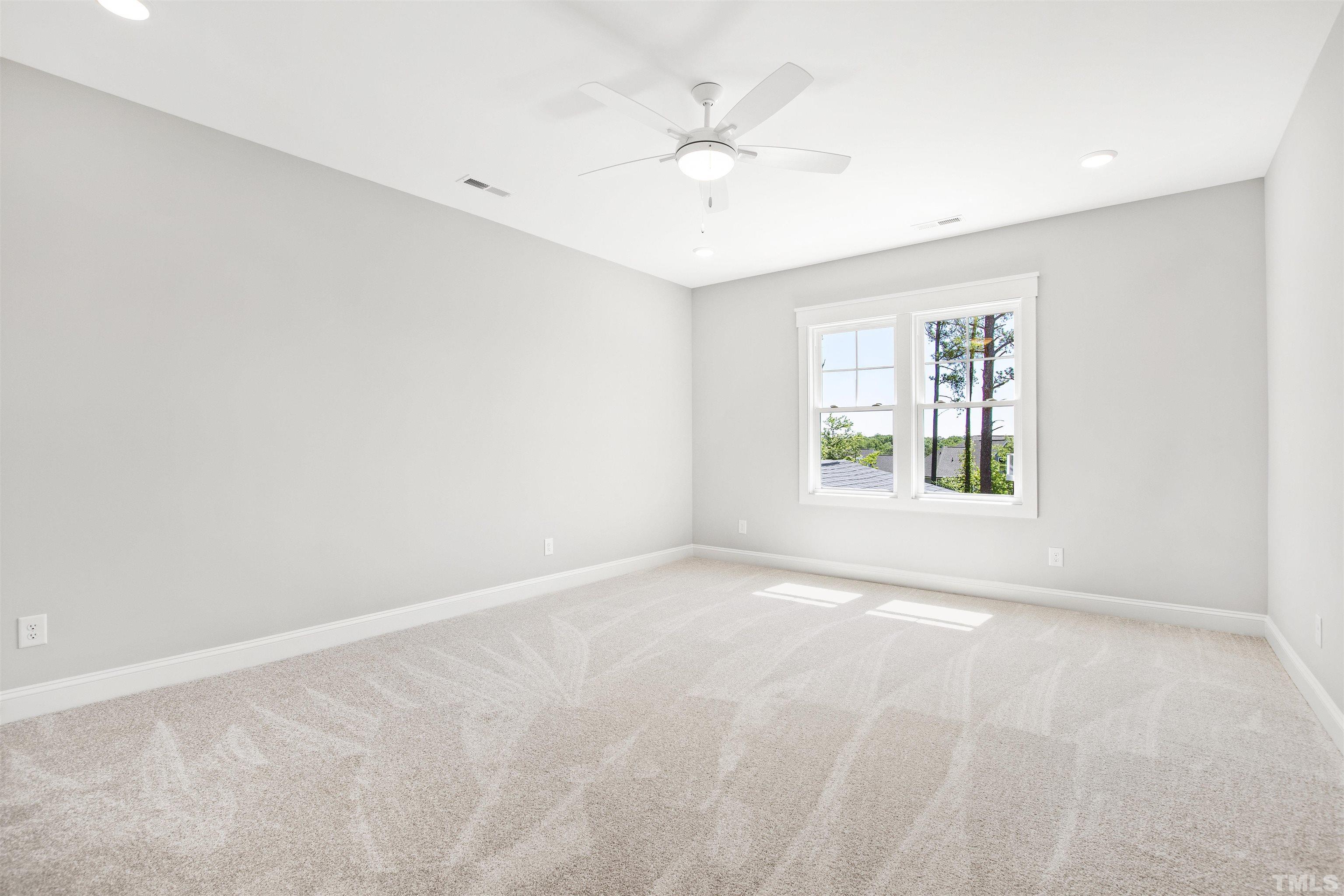 7512 Pinecrest Road Raleigh, NC 27613 - Photo 31 of 47 an empty room with windows and ceiling fan