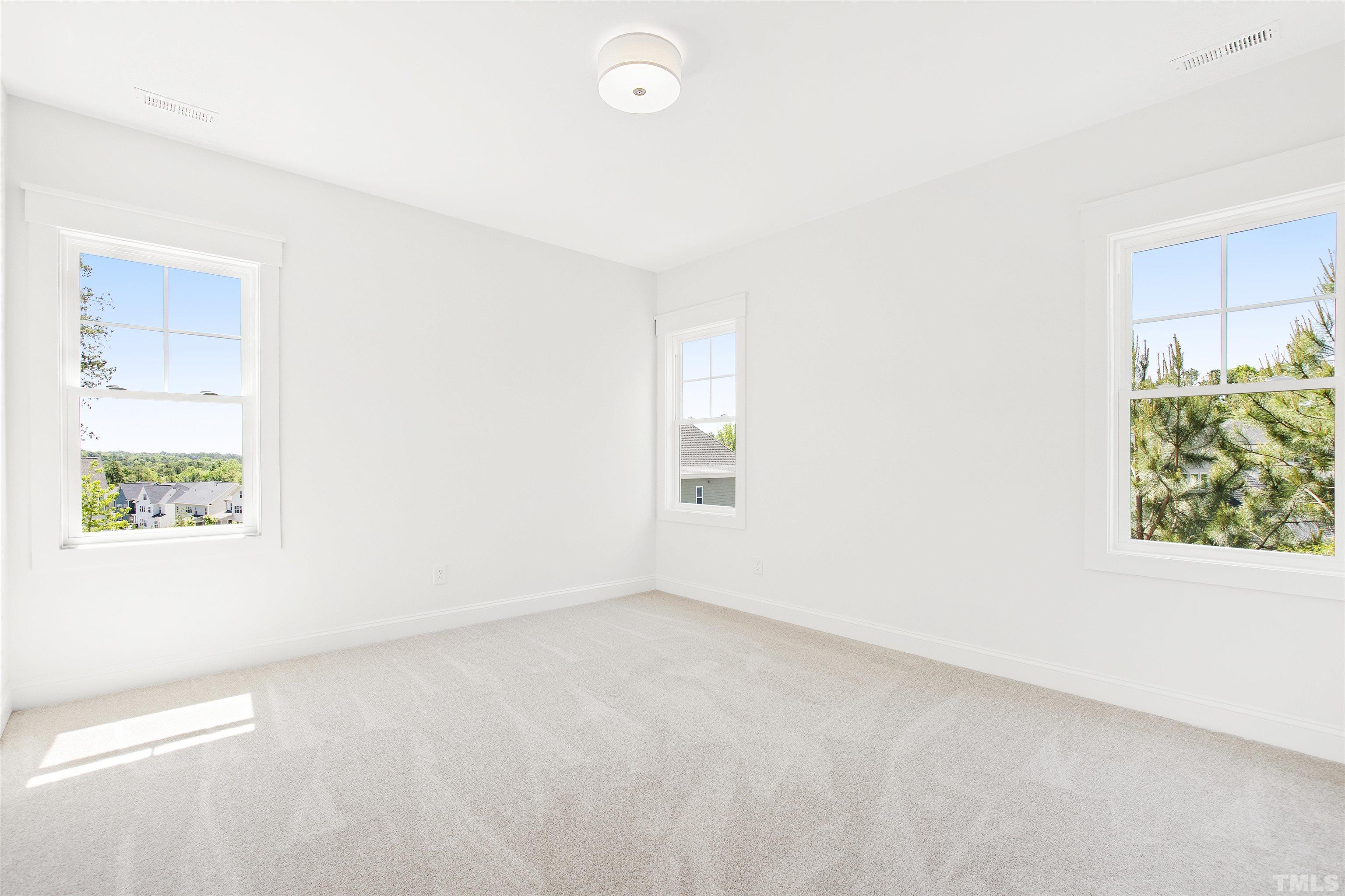 7512 Pinecrest Road Raleigh, NC 27613 - Photo 33 of 47 an empty room with windows