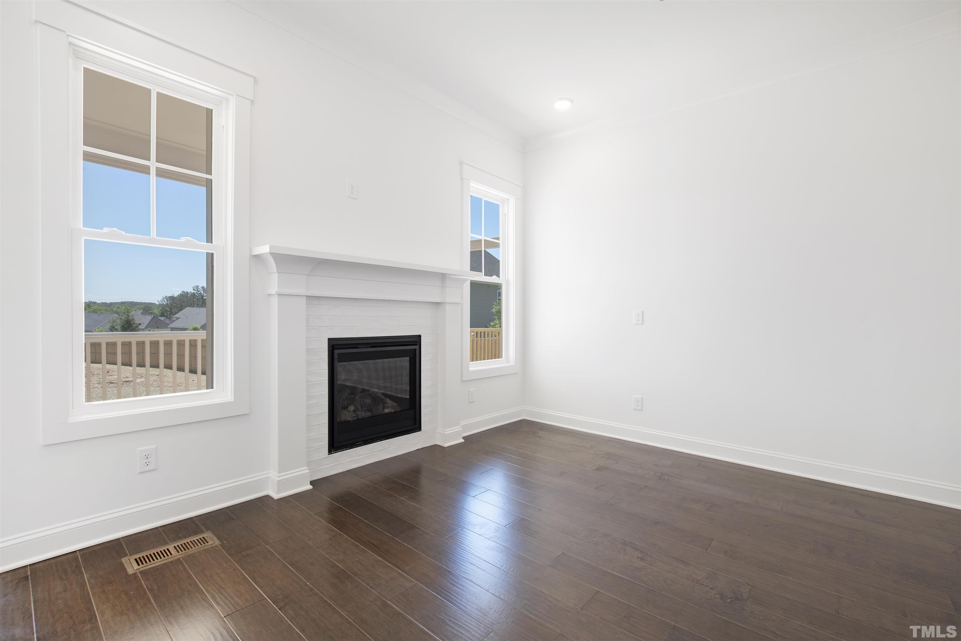 7512 Pinecrest Road Raleigh, NC 27613 - Photo 8 of 47 an empty room with wooden floor and a window