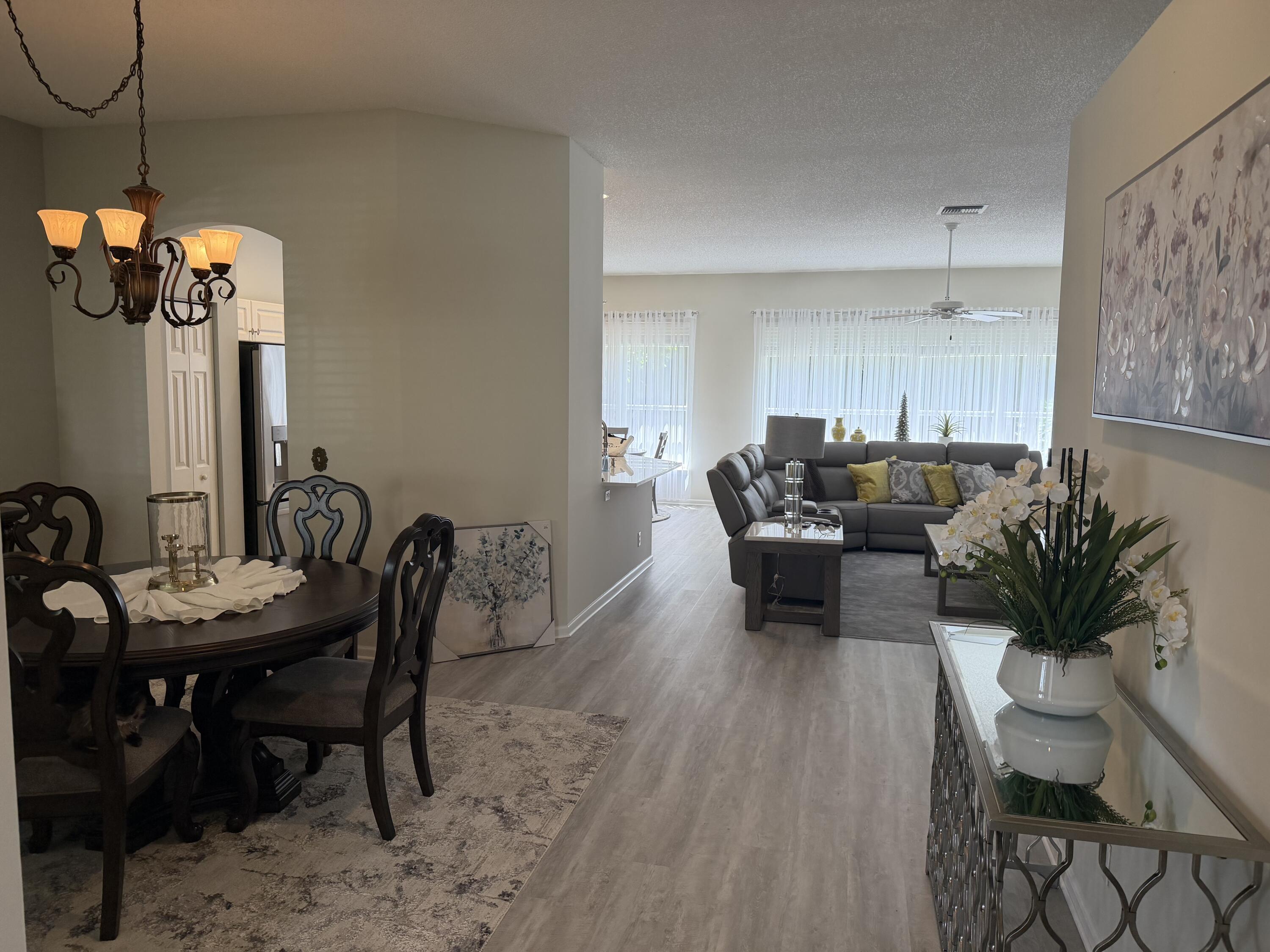 7936 Rockford Road Boynton Beach, FL 33472 - Photo 1 of 14 a living room with furniture and wooden floor