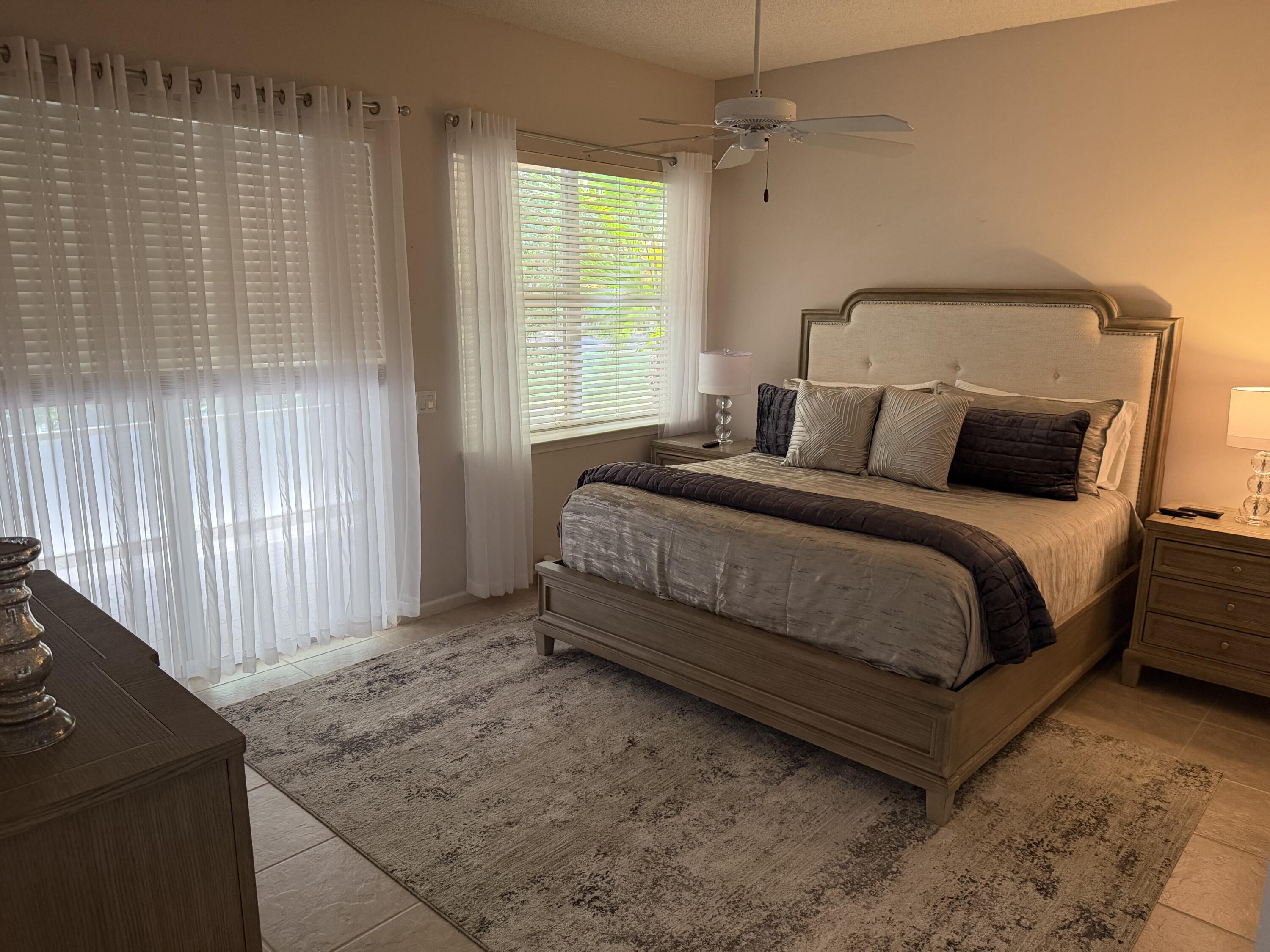 7936 Rockford Road Boynton Beach, FL 33472 - Photo 11 of 14 a bedroom with a bed and a window