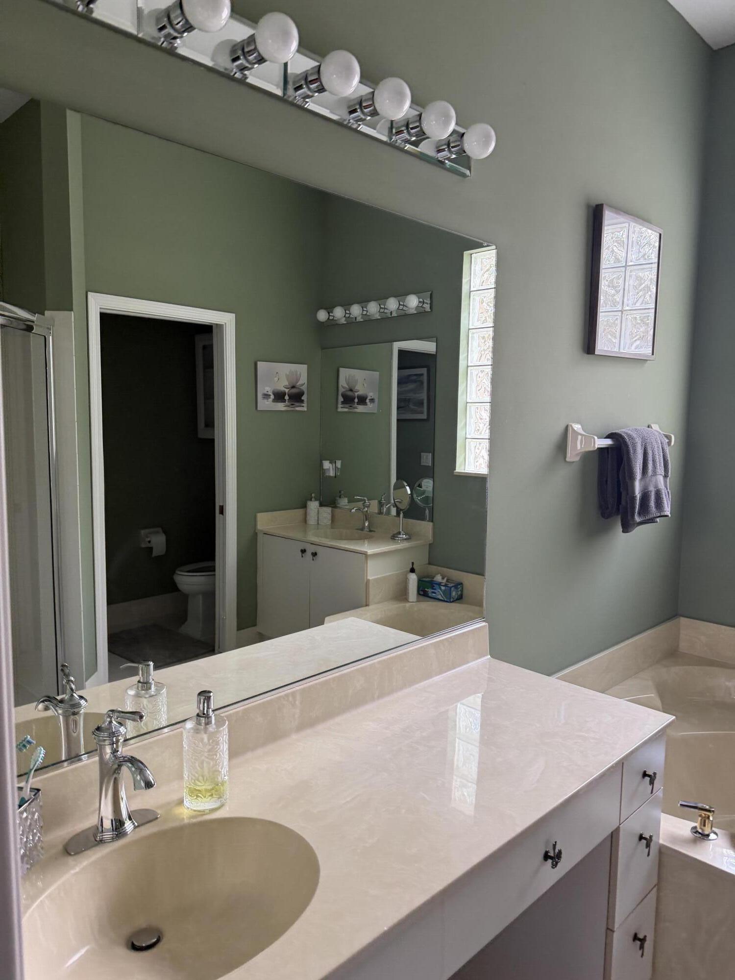 7936 Rockford Road Boynton Beach, FL 33472 - Photo 12 of 14 a bathroom with a sink double vanity and a mirror