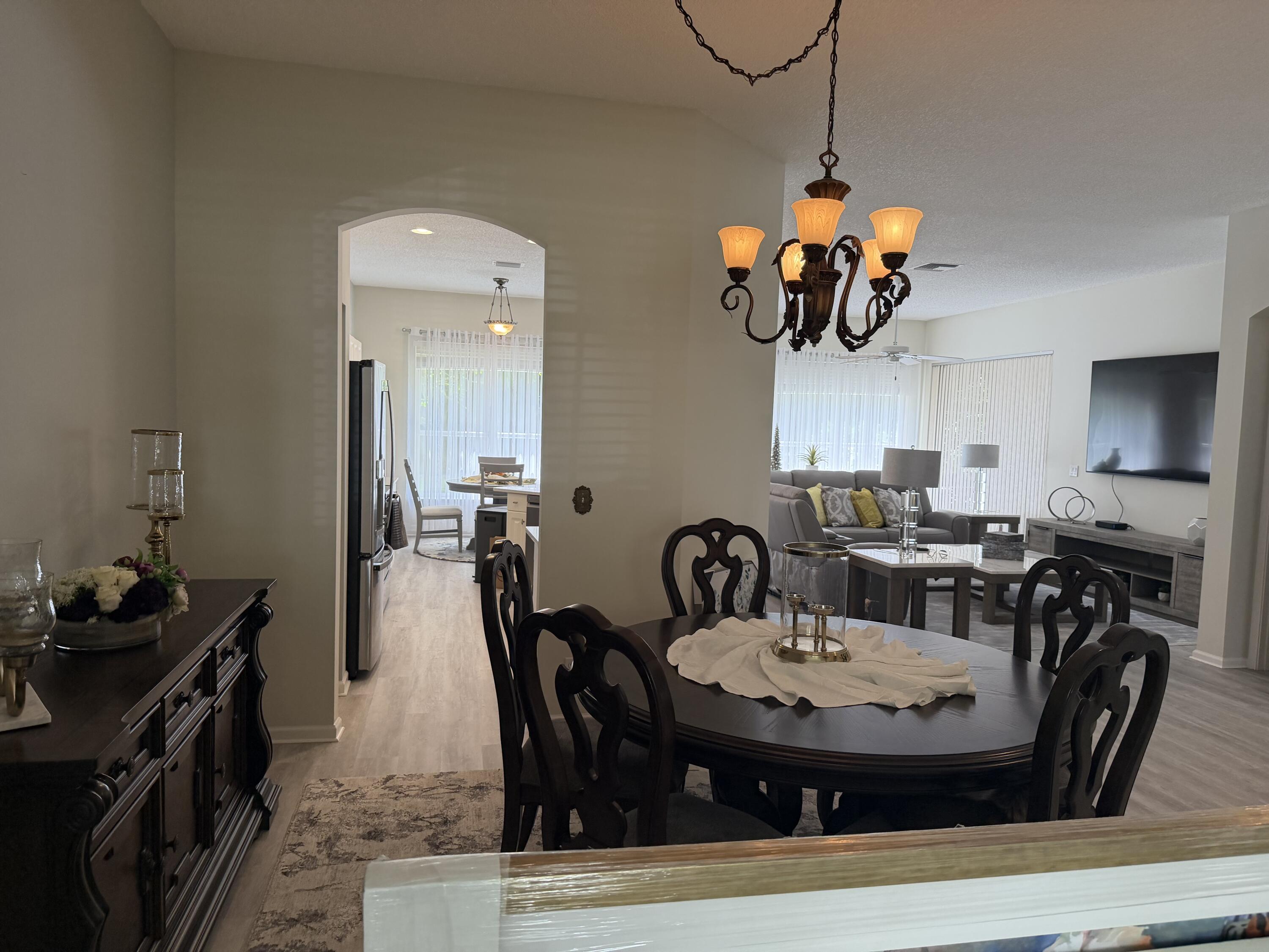 7936 Rockford Road Boynton Beach, FL 33472 - Photo 2 of 14 a view of a dining room with furniture and a chandelier