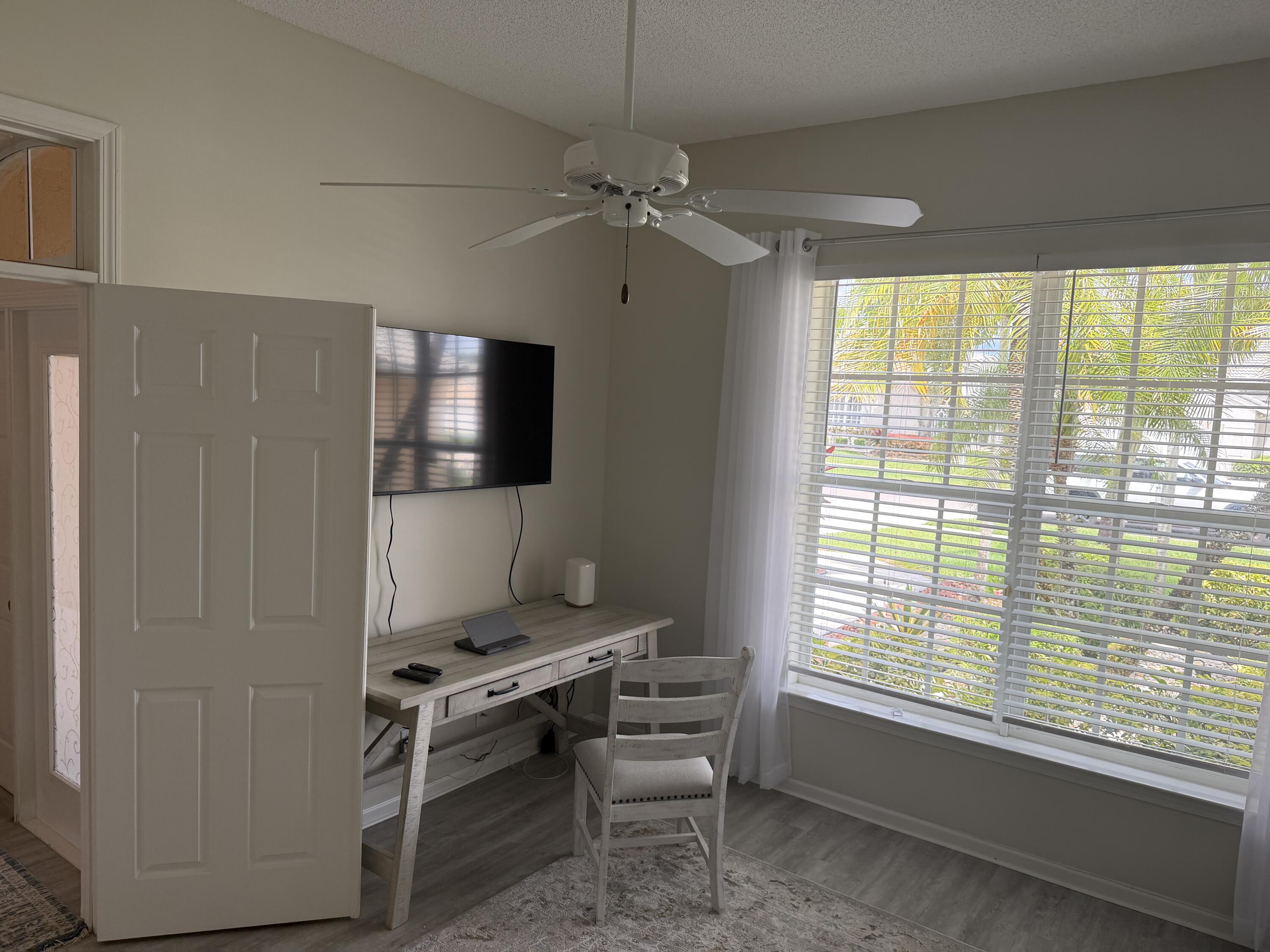 7936 Rockford Road Boynton Beach, FL 33472 - Photo 9 of 14 a living room with furniture and a flat screen tv