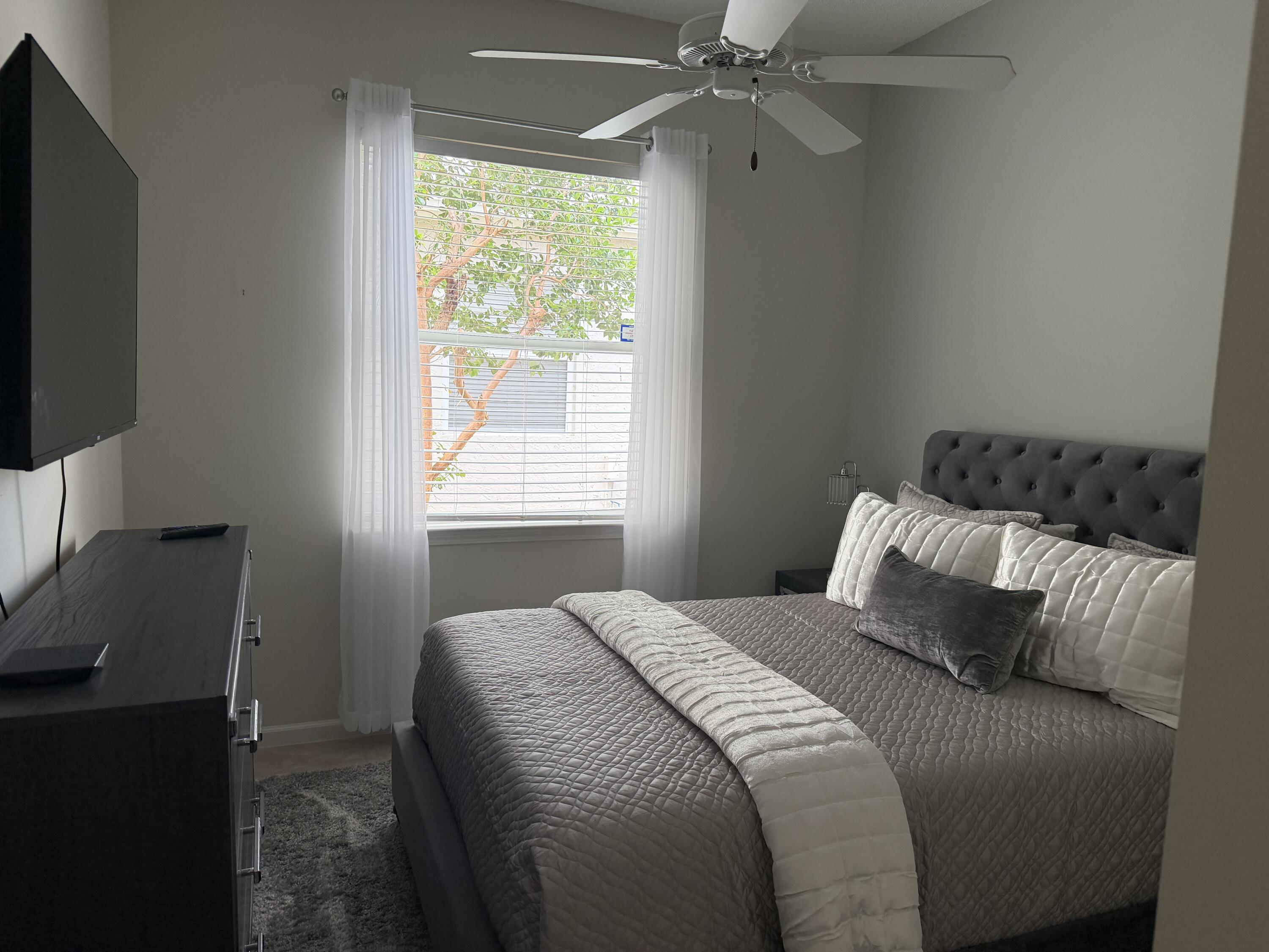 7936 Rockford Road Boynton Beach, FL 33472 - Photo 10 of 14 a bedroom with a bed and a window