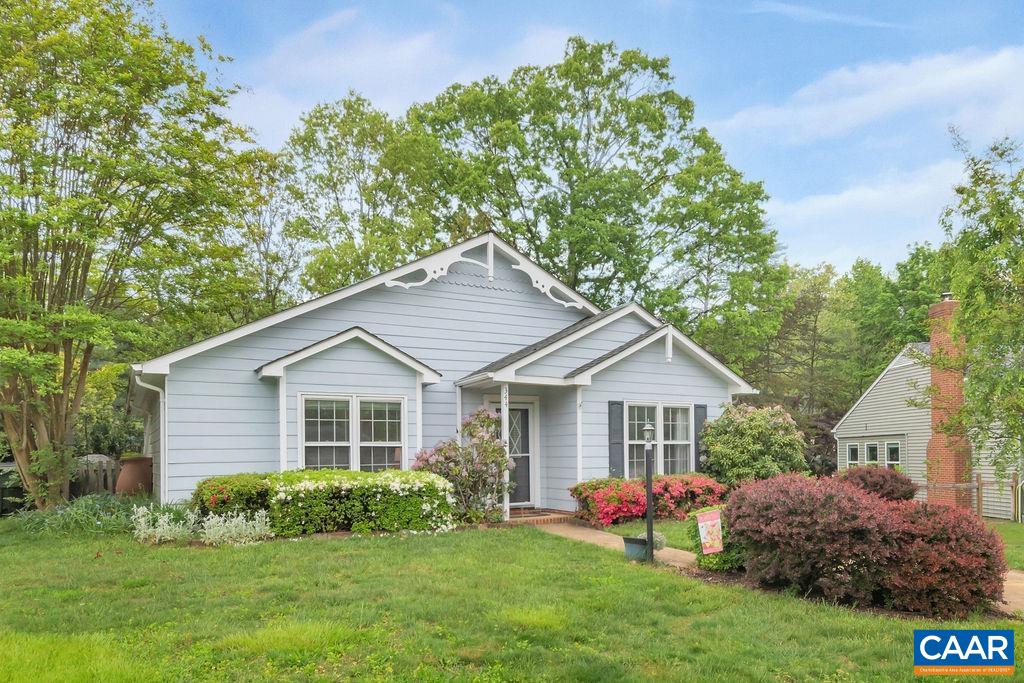 a front view of house with yard and green space