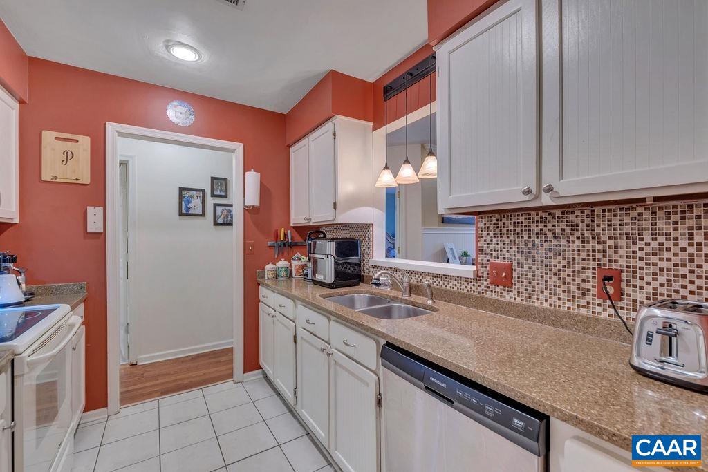 344 Minor Ridge Road Charlottesville, VA 22901 - Photo 13 of 53 a kitchen with stainless steel appliances granite countertop a sink stove and cabinets