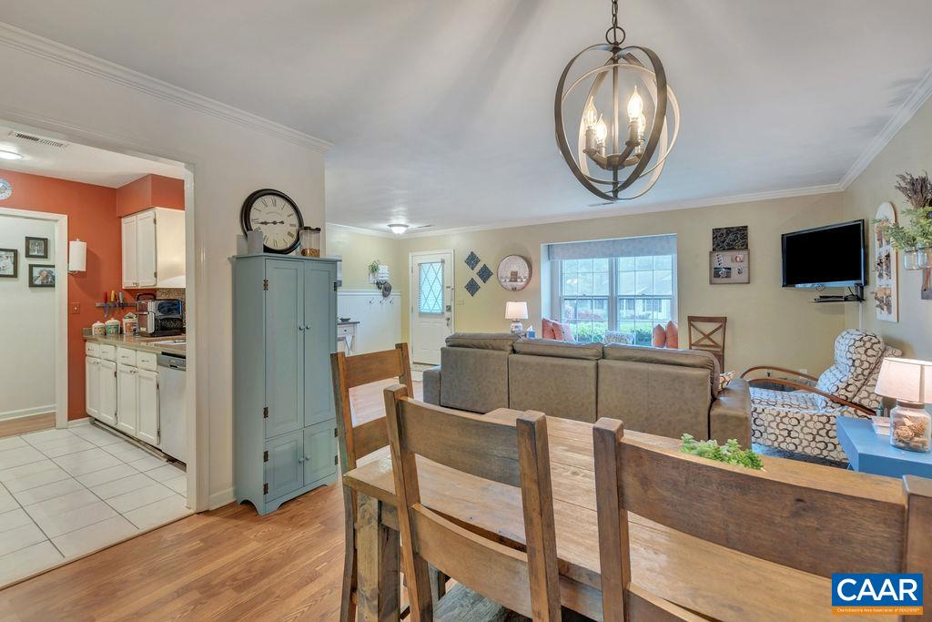 344 Minor Ridge Road Charlottesville, VA 22901 - Photo 10 of 53 a view of a dining room with furniture a chandelier and wooden floor