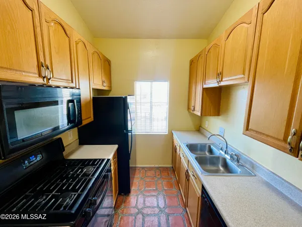 a kitchen that has a sink and a stove in it