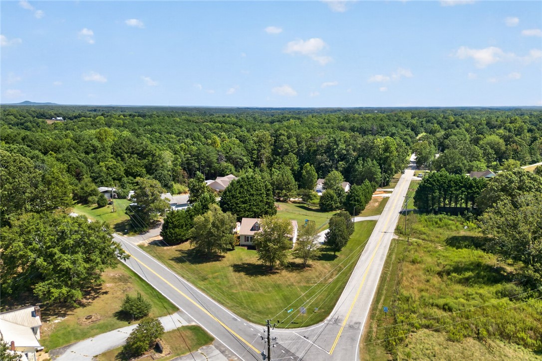 564 Fairfield Road Walhalla, SC 29691 - Photo 40 of 50 An aerial perspective showcases a corner lot nestled among mature trees and rolling green landscapes.