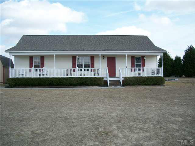 57 Rodney Court Willow Spring, NC 27592 - Photo 1 of 16 a front view of a house with a yard and garage