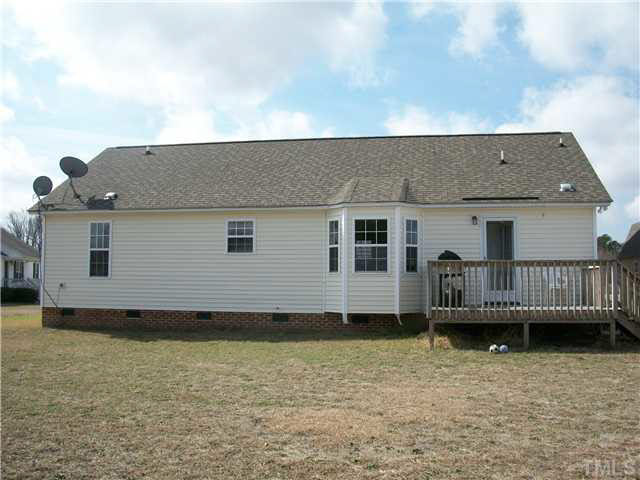 57 Rodney Court Willow Spring, NC 27592 - Photo 16 of 16 a view of a house with a wooden deck