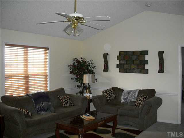 57 Rodney Court Willow Spring, NC 27592 - Photo 4 of 16 a living room with furniture and a large window