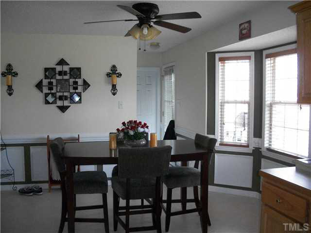 57 Rodney Court Willow Spring, NC 27592 - Photo 7 of 16 a view of a dining room with furniture and a chandelier