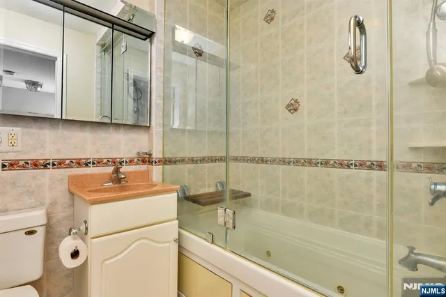 a bathroom with a sink a mirror and a shower